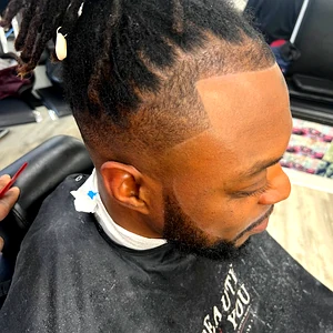 Men's loc fade haircut by Fwresh Salon and Barbershop